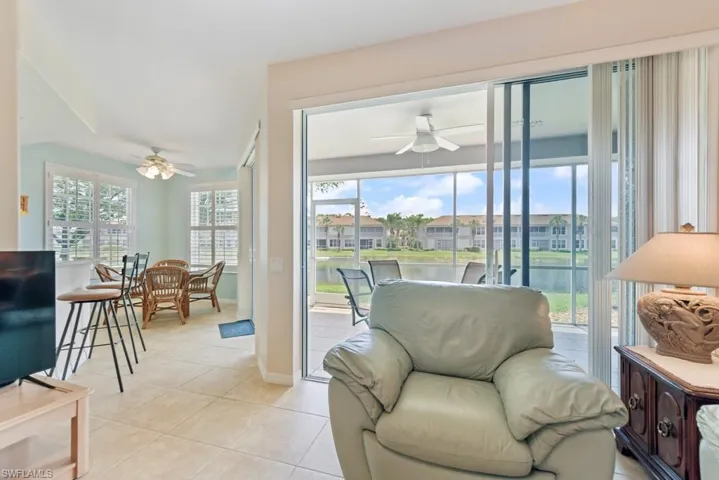 Sunny Living room with a ceiling fan, and light tile floors