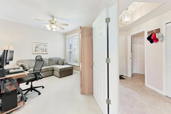 Office space with ceiling fan and carpet