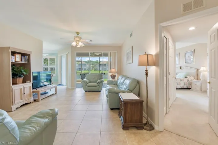 Tiled living room featuring ceiling fan