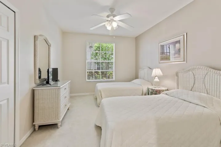 Bedroom featuring light carpet and ceiling fan