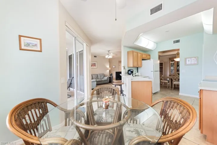 Dining room featuring ceiling fan and light tile flooring