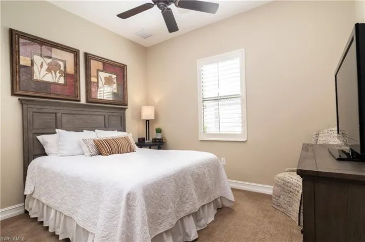 Guest bedroom with ceiling fan, plantation shutters