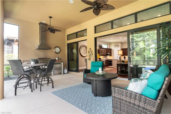 View of patio with outdoor lounge area and ceiling fan