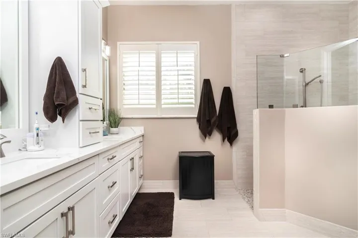 Master Bathroom with vanity and a tile shower