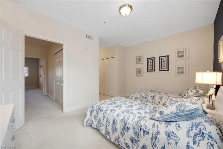 Carpeted upstairs bedroom featuring a closet