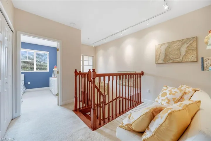 Loft/bonus area with light colored carpet