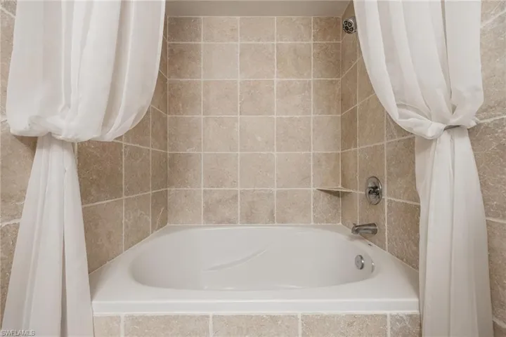 View of primary bathroom tub & shower