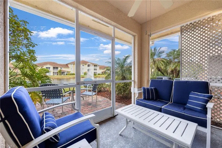Sunroom with ceiling fan and a water view