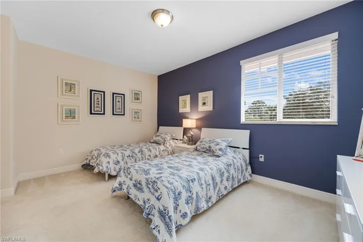 Carpeted upstairs bedroom featuring a closet