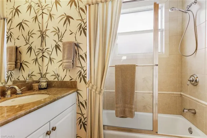 Bathroom with vanity and shower / tub combo