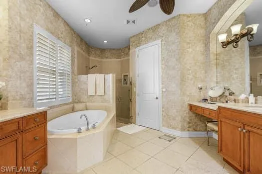 Bathroom featuring vanity, ceiling fan, tile patterned floors, and shower with separate bathtub