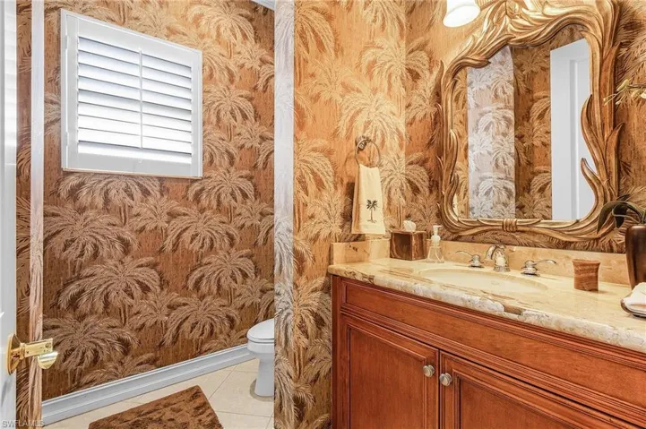 Bathroom with vanity, toilet, and tile patterned flooring