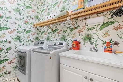 Washroom with cabinets and washing machine and clothes dryer