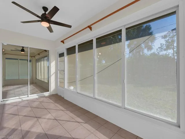 Unfurnished sunroom featuring ceiling fan