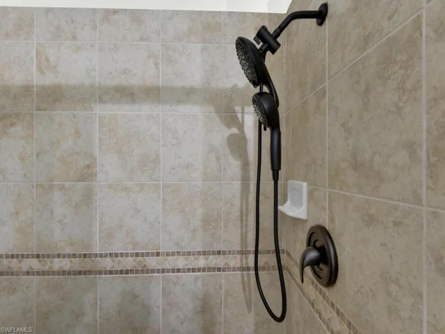 Room details featuring tiled shower
