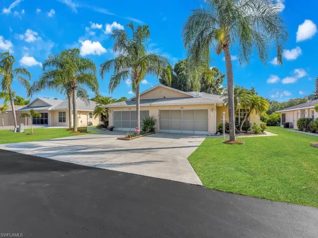 Single story home featuring a garage and a front yard