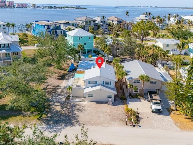 Aerial view of residential area featuring a nearby body of water
