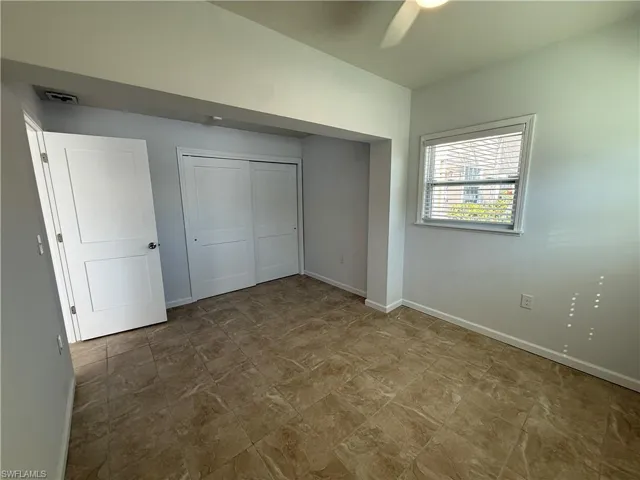 Unfurnished bedroom with a closet and a ceiling fan