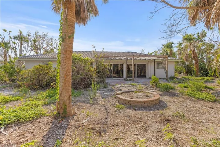 Back of property featuring a pergola and a patio area