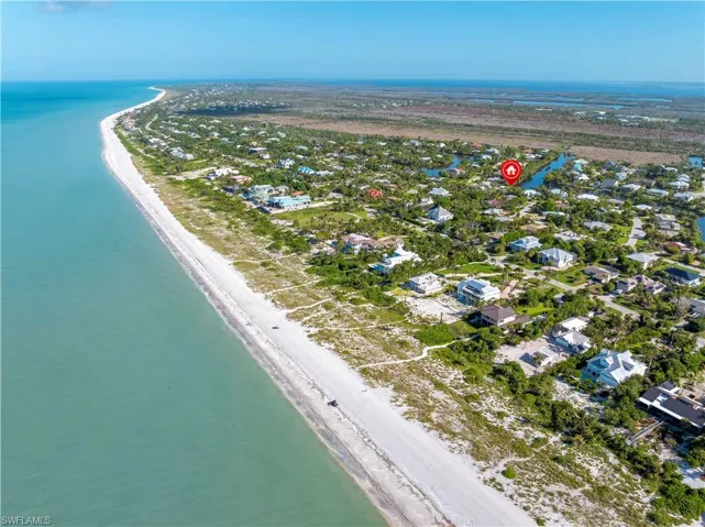 Drone / aerial view with a view of the beach and a water view