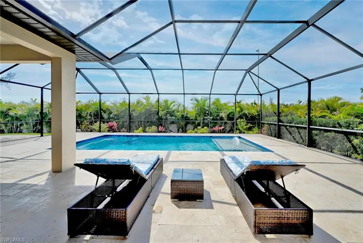 View of swimming pool with a patio, a lanai, and an outdoor living space