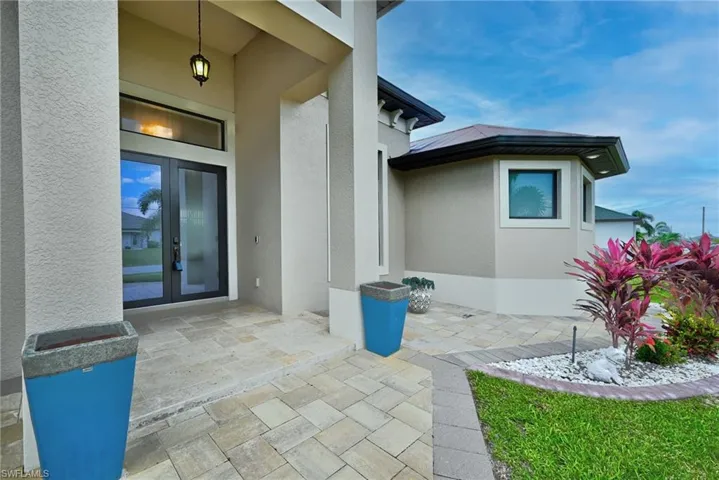 View of exterior entry featuring a patio and french doors