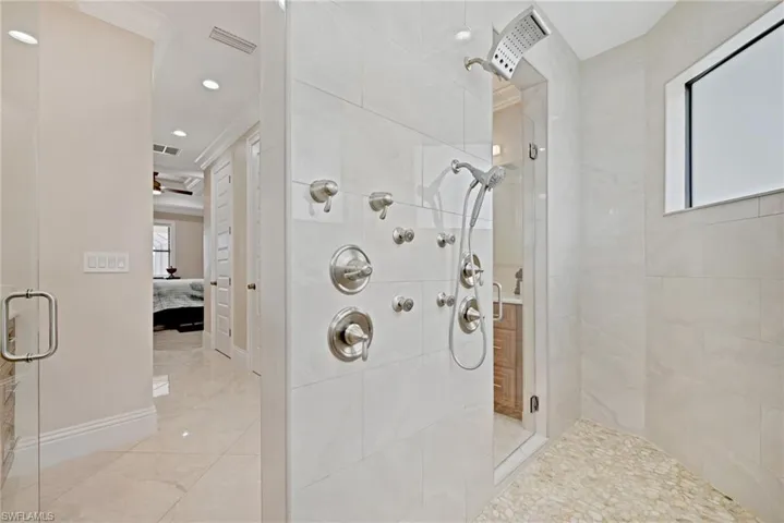 Bathroom featuring walk in shower, tile flooring, ornamental molding, and ceiling fan