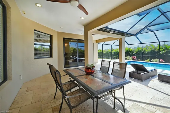 Sunroom / solarium featuring ceiling fan