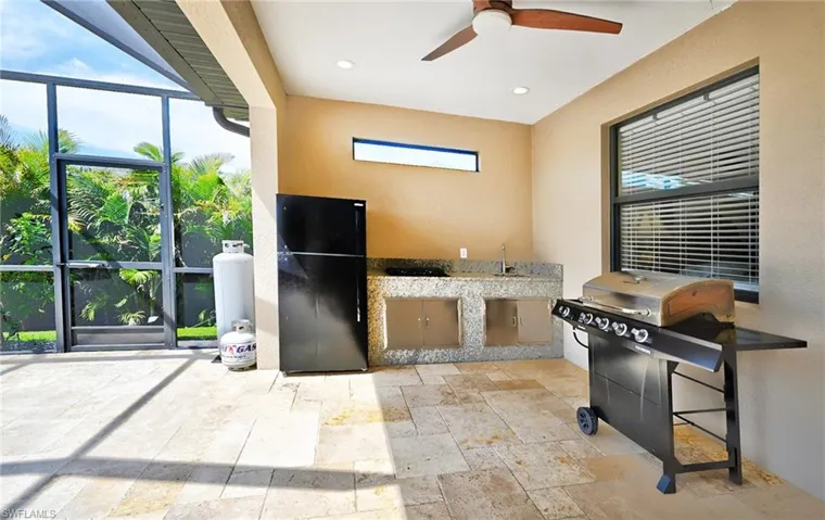 Tiled office space featuring plenty of natural light and ceiling fan