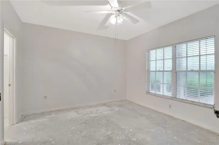 Spare room featuring concrete flooring and ceiling fan