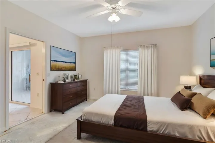 Bedroom featuring light carpet and ceiling fan