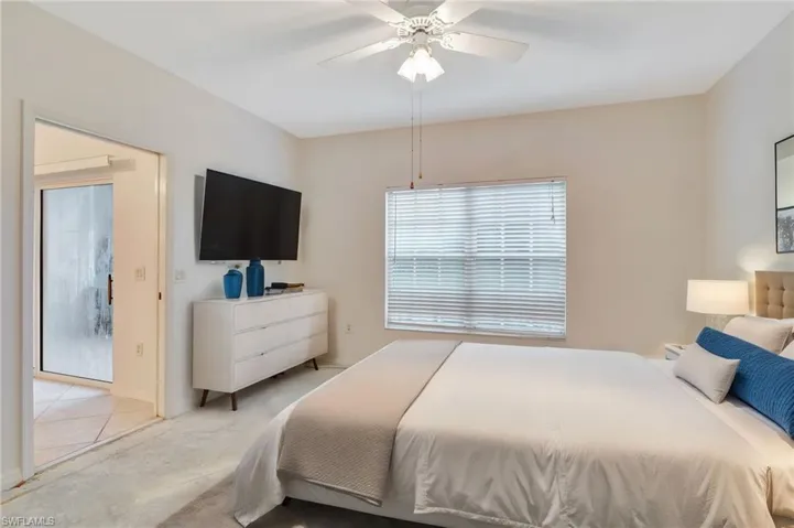 Bedroom featuring light tile patterned floors and ceiling fan