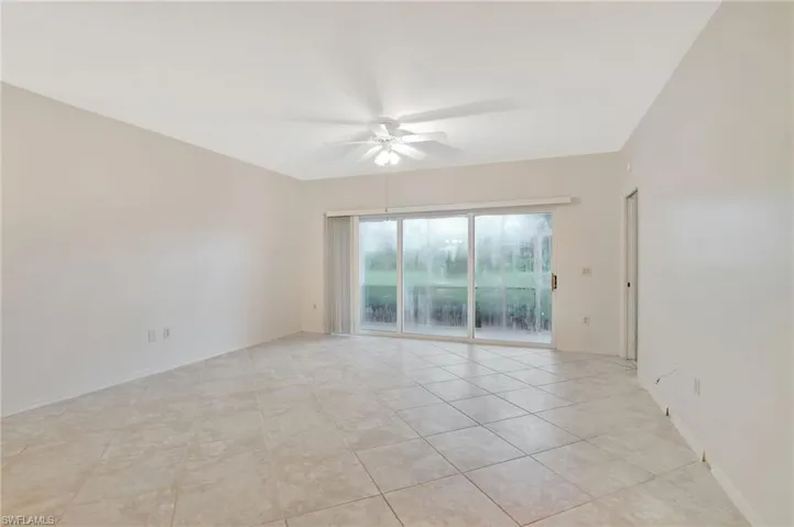 Spare room featuring light tile patterned floors and ceiling fan