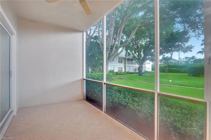 Unfurnished sunroom featuring ceiling fan