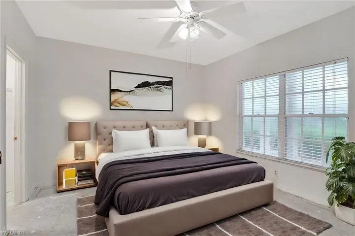 Bedroom featuring ceiling fan and concrete floors