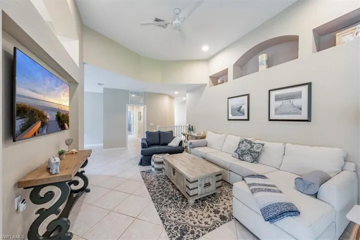 Living room with volume ceilings.  Offered Turnkey!