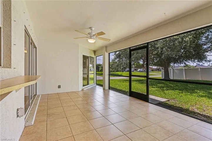 Unfurnished sunroom with ceiling fan