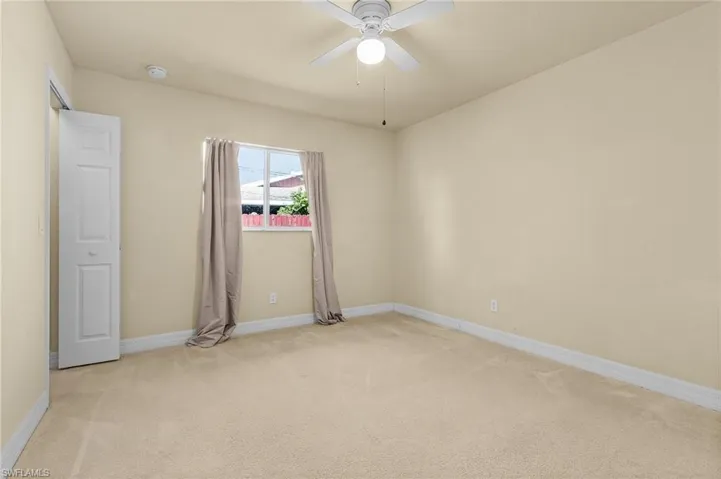 Spare room with carpet flooring and ceiling fan