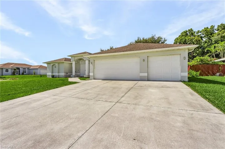 Ranch-style home featuring a garage and a front yard