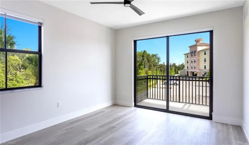 Spare room with baseboards, wood finished floors, and ceiling fan