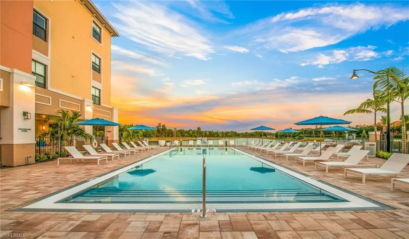 Community pool featuring a patio and fence