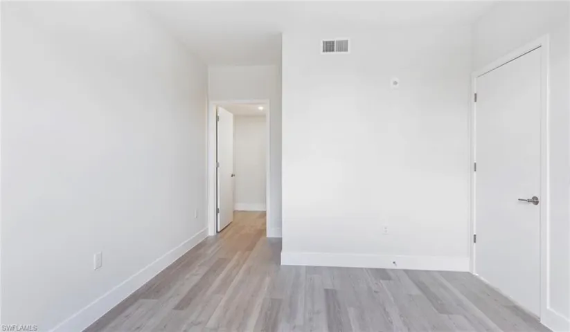 Unfurnished room with light wood-style flooring, baseboards, and visible vents