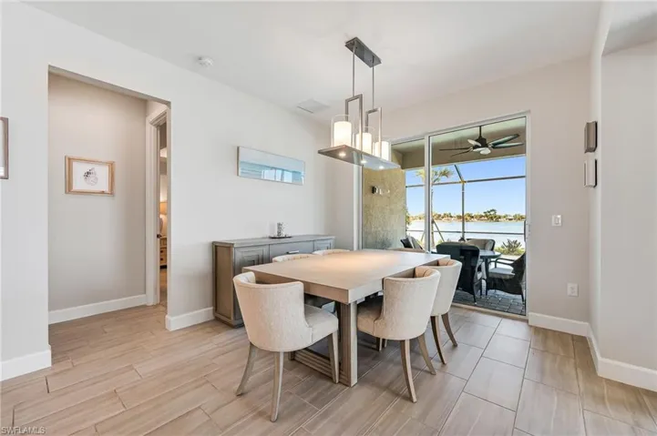 Dining area with access to lanai and pool