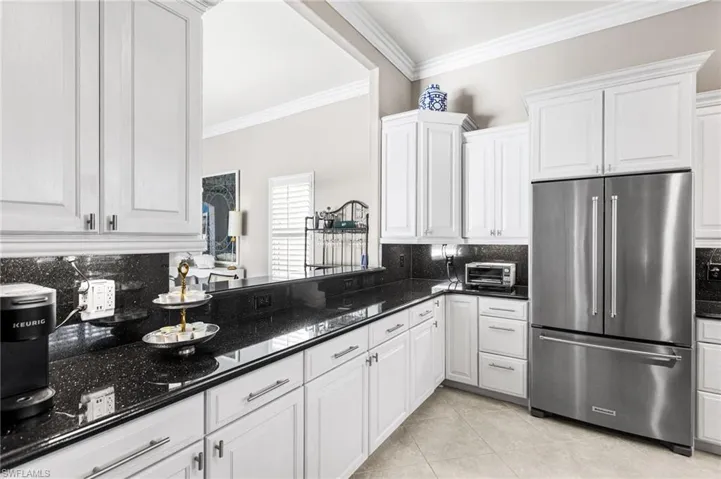 Granite countertops adorn the white custom cabinetry.