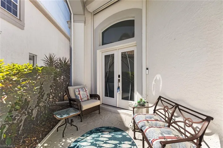 Your screened in lanai/entryway has custom etched glass double doors. Hurricane protection.