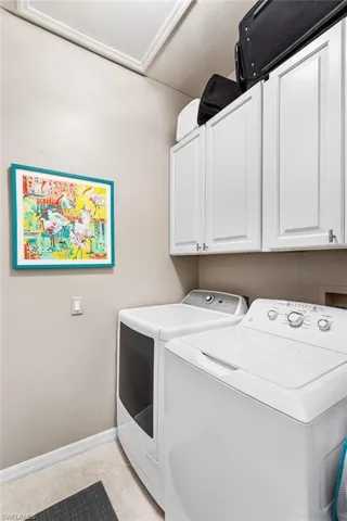 Laundry room offers extra storage.