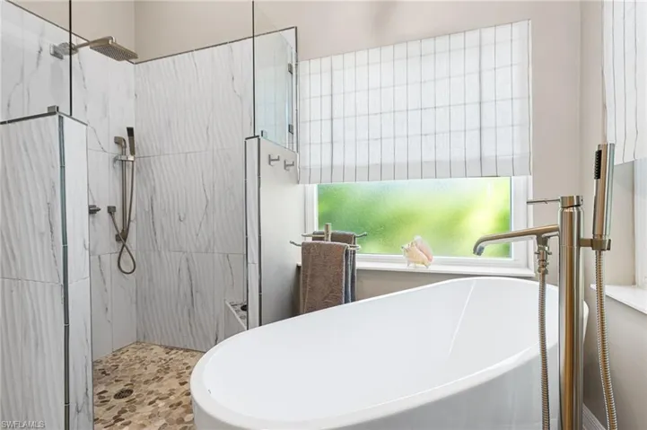 Free standing soaking tub and a seamless glass walk in rain shower. Lots of natural light spills in all through this home.