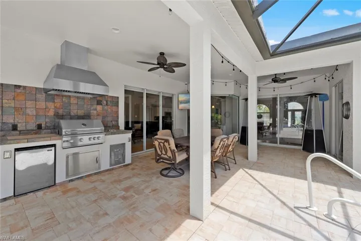 View of patio / terrace with ceiling fan, an outdoor kitchen, and area for grilling