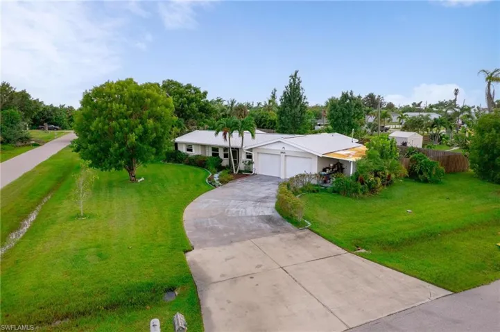 Single story home featuring a front yard and a garage