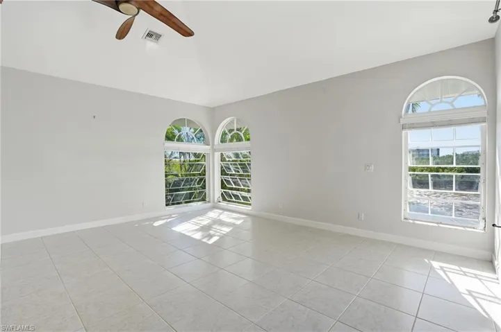 Spare room with ceiling fan and light tile patterned flooring - Virtually Edited Image